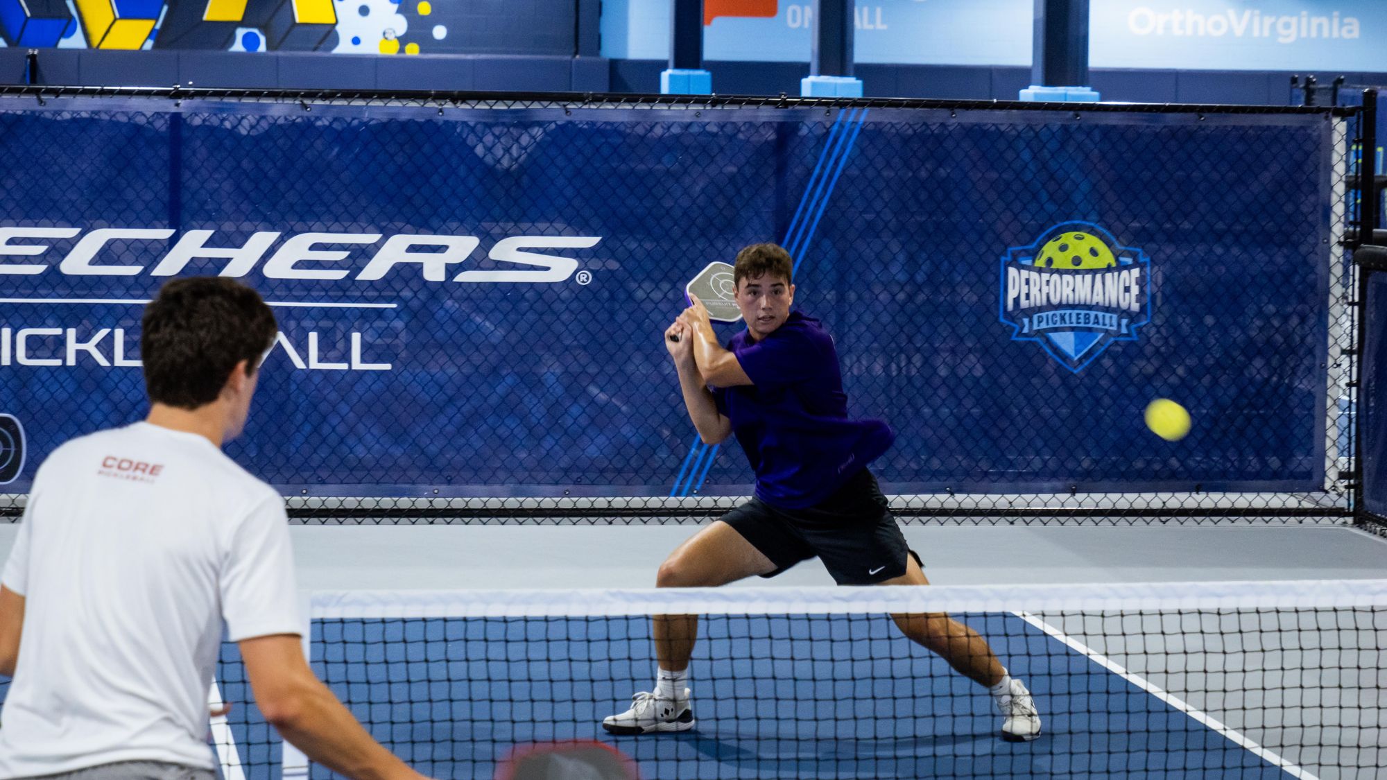 Ryan hitting a backhand at the net in competition