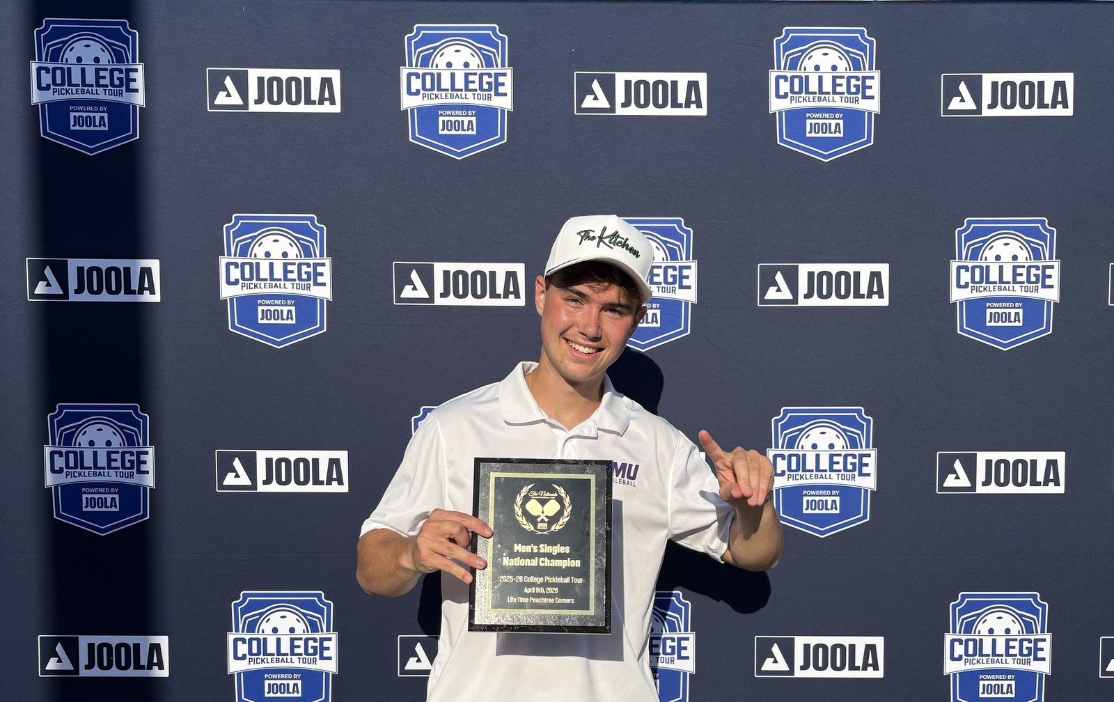 Ryan Morneau holding the Men's Singles National Champion plaque